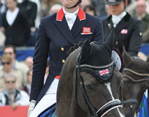 An emotional Charlotte Dujardin bites her lips while the British national anthem is playing to honour her world record scoring victory in the Grand Prix Special at the 2012 CDI Hagen :: Photo © Selene Scarsi