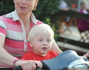 Isabell Werth with her son Frederik on the scooter