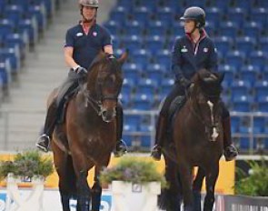 Carl Hester and his student Charlotte Dujardin hacking their horses in the main stadium