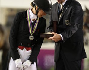 Agnete Kirk Thinggaard looks at the Longines watch which German team captain Klaus Roeser received