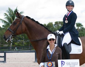 Marcela Parra of Piaffe Performance presents the Piaffe Performance Adult Amateur Achievement Award to Dr. Heather Boo, riding Divertimento