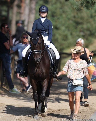 Finnish Grand Prix rider and trainer Mikaela Lindh accompanying her student Aino Hirvonen on D (by San Remo x Balzflug)