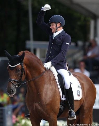 Matthias Rath raises his fist as he wins silver on Destacado at his first World Young Horse Championships