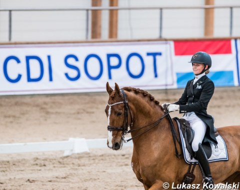 Ida Persson and Tago with the CDI Sopot banner in the background
