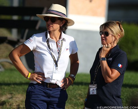 French Dressage Director Emmanuelle Schramm and French youth team captain Muriel Leonardi listen to the scores as the score board was not switched on today