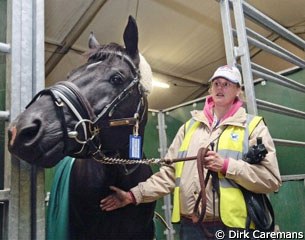 Groom Vanessa Ruiter and WEG gold medal hopeful Totilas are waiting in a temporary stall before being loaded into his container.