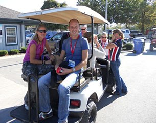 Adelinde Cornelissen and Hans Peter Minderhoud share a ride on the golfcart