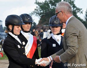 FEI Dressage Director Trond Asmyr hands the bronze medal to the Danish team