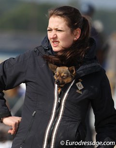 Dog using owner and her coat as windbreaker