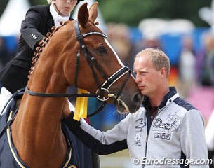 Ingo Pape cuddling with his mare at the prize giving, before getting run over by her