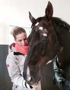 Anna Kasprzak pats and cuddles Donnperignon after he came out of the recovery room from eye surgery