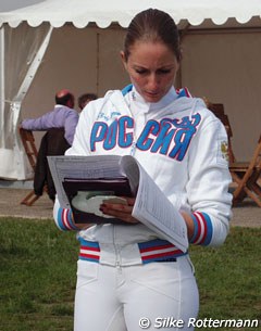 Russian rider Diana al Shaer looks at her score sheets
