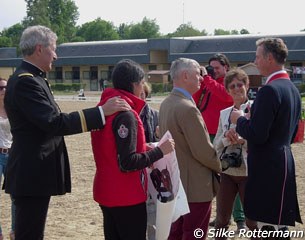 Philippe Limousin helps a French fan to get an autograph from Carl Hester and Charlotte Dujardin