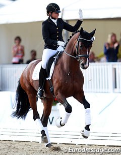 Dorothee Schneider waves to the crowds in her lap of honour on Stanford at the 2014 World Young Horse Championships :: Photo © Astrid Appels