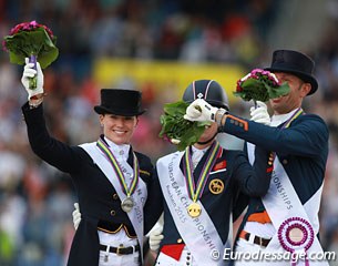 The Grand Prix Special podium: Sprehe is all smiles while Dujardin and Minderhoud frolick about holding the bouquets in front of the other's face to prevent photographers from taking a proper photo
