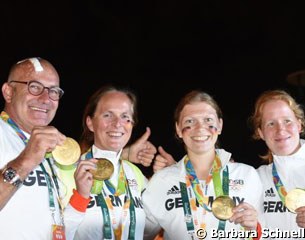 The German grooms wearing the team gold medal