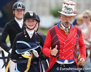 Semmieke Rothenberger in her lap of honour with ringmaster and show clown Pedro Cebulka blowing a whistle