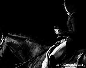 Morgan Barbançon on Sir Donnerhall II with a glass of champagne offered to every rider after his test