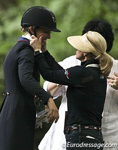 Trainer Debbie McDonald squeezes Laura Graves' cheeks after the prize giving ceremony
