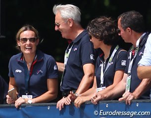 French team trainer Jan Bemelmans gives Arnaud Serre's wife Anne Sophie a pat on the back