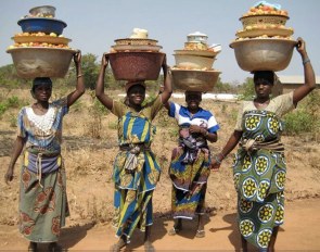 As part of the culture in many parts of the world, especially on the African continent, many women grow up carrying things (such as bowls) on their heads.  Although perhaps some of us have tried to take a few steps with a book on our heads for posture, it is almost unimaginable to think about carrying something with such weight. And for miles and miles every day! So you might be asking yourself...what does THIS have to do with riding? The answer is: A LOT!