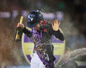 Lottie Fry getting a champagne shower after winning freestyle gold at the 2022 World Championships Dressage :: Photo © Astrid Appels