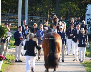 Frederic Wandres looking at Ingrid Klimke trotting up Vayron at the 2025 European Dressage Championships :: Photos © Astrid Appels