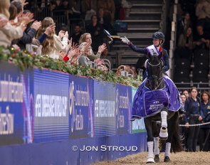 Fry throws her ribbon into the crowds during her lap of honour on Glamourdale at the 2025 CDI-W London :: Photo © Jon Stroud