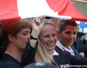 Victoria Max Theurer and her Austrian team mates shelter under their country's flag