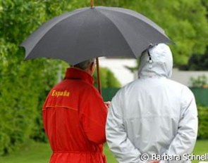 Rain rain go away! Jan Bemelmans wearing the Spanish team coat and covering from the rain.