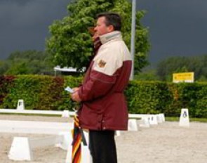 The Special day was one with torrential down pours. Holger Schmezer is watching Linsenhoff warm up but the thunder storm is approaching rapidly