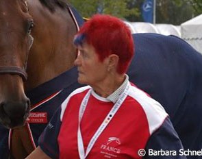 A French groom walking a horse