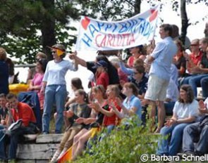 Carlotta Hassenburger's fans celebrate and bring out a banner for her 14th birthday