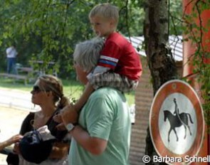 No riding here, says the sign, except on your father's shoulder. Nora Knutsen's family waiting for the score