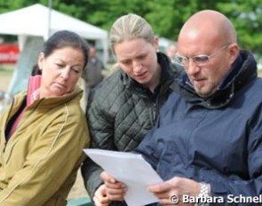 Gaby Winkelhues and Desiree & Adolf Theo Schurf (owner of Dressman) study the start list.