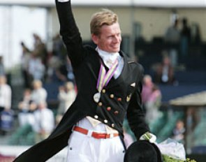 Edward Gal waves with a crystal trophy to the crowds