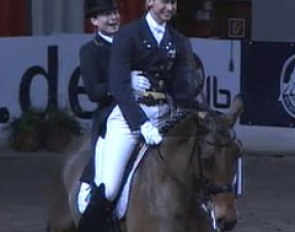 Isabell Werth and Patrik Kittel share the ride on First Class for the 2009 CDI Bremen lap of honour