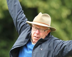 Danish trainer Bjarne Nielsen joking around: pretending he's falling off a fence