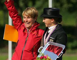 Charlott Maria Schurmann and her mom on the podium. Her mom received a trophy for being the groom of the gold medal winning horse