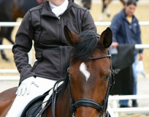 Isabell Werth and El Santo NRW in the warm up ring. Werth having a chat