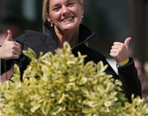 Belgian junior rider Noemie Goris lends a hand and picks up the protocols at the judges' boxes during the FEI Pony Team Test