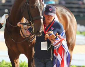 Two Sox is interested in what his groom has in her hands during the Grand Prix team prize giving :: Photo © Astrid Appels