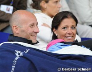 The first day at Aachen was freezing cold: Belgians Jeroen Devroe and Carmen de Bondt warm up underneath a horse blanket