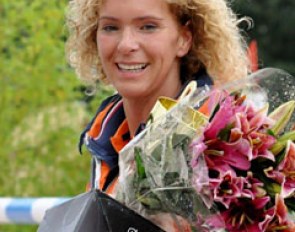 Dana's mom Nicolette is all smiles with her daughter's trophy and flowers in hand