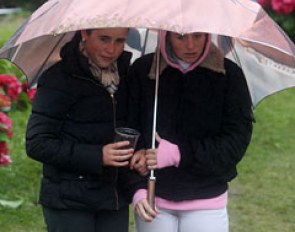 Sisters Marie and Julie van Olst sheltered under a big umbrella