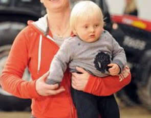 Isabell Werth carrying her son Frederik
