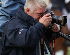 Belgian photographer Dirk Caremans taking photos of the riders, trainers and fans celebrating in the warm up