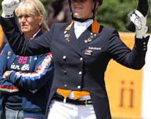 Van Lierop raises her fists when she sees her winning score flash on the board