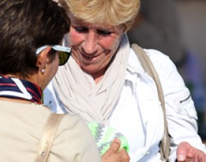 O-judge Francis Verbeek proudly shows her hand-made knitwear to O-judge Maribel Alonso