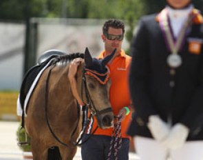 Champ of Class gets cuddled while Lisanne Zoutendijk stands on the podium